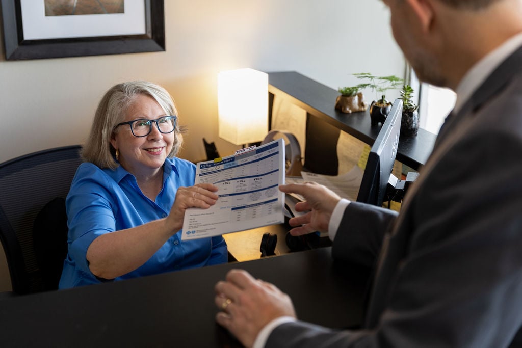 woman handing info to a man